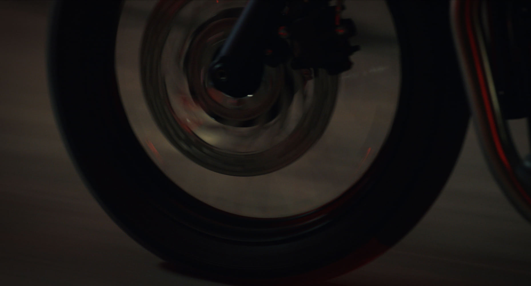 Detail of a motorcycle wheel driving over the ground. 